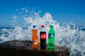 Coca-cola, fanta, sprite bottles on rock