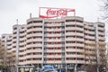 The Coca Cola logo advertising neon light letters on building roof in Berlin, Germany