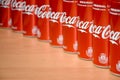 Coca-Cola logo printed on aluminium cans and placed on shopping mall table Royalty Free Stock Photo