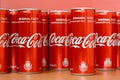 Coca-Cola logo printed on aluminium cans and placed on shopping mall table Royalty Free Stock Photo