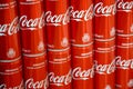 Coca-Cola logo printed on aluminium cans and placed on shopping mall table Royalty Free Stock Photo