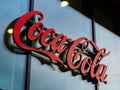 Coca Cola Logo Sign on a Modern Glass Wall Royalty Free Stock Photo