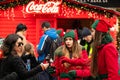 Coca Cola promoters giving away free drinks to people during Christmas holiday promotion campaign on city street Royalty Free Stock Photo