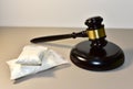 Cocaine and Judge hammer in courtroom. Legal excuse and Justice concept. Sentence to a criminal for committing a drug offense. Royalty Free Stock Photo