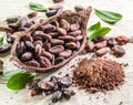 Cocao powder and cocao beans on the wood.