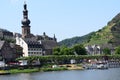Cochem, Germany - 06 17 2021: old town with ship departure and a small boat passing
