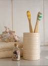 Cockleshell, Bath white cotton towels and bamboo toothbrushes on Blurred bathroom interior background with sink and faucet Royalty Free Stock Photo