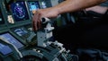 Pilot holding hand on the thrust lever handle for engine control of airliner. Royalty Free Stock Photo