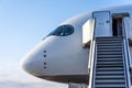 The cockpit and the entrance to the aircraft for passengers with a ladder and stairs up