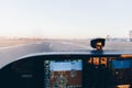 Cockpit of a small plane landing on the airport runway at sunset Royalty Free Stock Photo