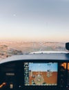 Cockpit of a small plane landing on the airport runway at sunset Royalty Free Stock Photo