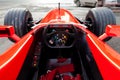 Cockpit and steering wheel view of red Ferrari racing sports cars for Formula 1 on the street near the garage box Royalty Free Stock Photo