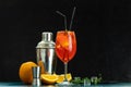 Cocktail aperol spritz in big wine glass with water drops on dark background