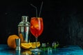 Cocktail aperol spritz in big wine glass with water drops on dark background. Summer alcohol cocktail with orange slices