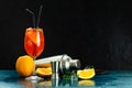 Cocktail aperol spritz in big wine glass with water drops on dark background. Summer alcohol cocktail with orange slices