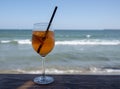 Cocktail aperol-spritz over the sea background. Royalty Free Stock Photo