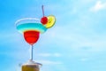 Cocktail on beach, blue sea and sky background
