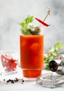 Cocktail bloody mary with shaker and strainer on light background with hot red pepper Royalty Free Stock Photo