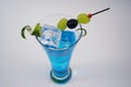 Cocktail blue drink with fruit on the rocks isolated at white Royalty Free Stock Photo