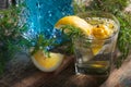 Cocktail with blue gin , tonic and lemon on a old wooden table