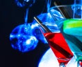 Cocktail with blue sparkling disco ball background with space for text Royalty Free Stock Photo