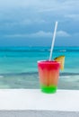 Cocktail with caribbean sea on background. Concept of beautiful tropical vacation Royalty Free Stock Photo