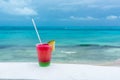 Cocktail with caribbean sea on background. Concept of beautiful tropical vacation Royalty Free Stock Photo