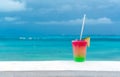 Cocktail with caribbean sea on background. Concept of beautiful tropical vacation Royalty Free Stock Photo