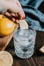 The cocktail with club soda, vodka, lemon and ice on a wooden table Royalty Free Stock Photo