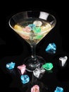 Cocktail with colored ice on a black background