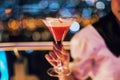 cocktail cosmopolitan in woman hand with bokeh Royalty Free Stock Photo