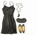 Cocktail dress outfit, night out look on white background. Little black dress, evening bag, black shoes, black tassel necklace. Fl