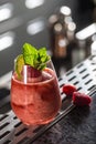 Cocktail drink frozen raspberries daiquiri at barcounter in night club or restaurant