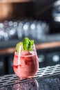 Cocktail drink frozen strawberry daiquiri at barcounter in night club or restaurant Royalty Free Stock Photo