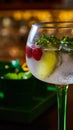 Cocktail experience featuring chilled gin and tonic with raspberries, mint, and lime Royalty Free Stock Photo