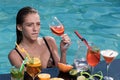 Cocktail with fruit at sexy girl in pool on maldives. Sensual woman in pool drink wine Royalty Free Stock Photo