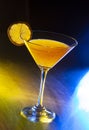 Cocktail of gin and tonic soda garnished by lemon slice on bar with blurry restaurant bar Low angle close up Royalty Free Stock Photo