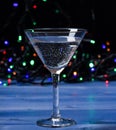 Cocktail glass on defocused garland colorful lights. Alcohol cocktail for winter party. Cocktail ideas concept. Easy Royalty Free Stock Photo