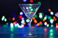 Cocktail glass on defocused garland colorful lights. What to drink on christmas party. Alcohol cocktail for winter party Royalty Free Stock Photo