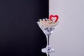 Cocktail glass full of jewelry and hearts. Royalty Free Stock Photo