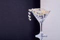 Cocktail glass full of jewelry and pearls. Royalty Free Stock Photo