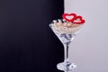 Cocktail glass with jewelry and hearts. Royalty Free Stock Photo