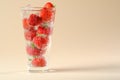 cocktail glass with red strawberries, sparkling water on bubbles on a beige background Royalty Free Stock Photo