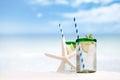 Cocktail with ice, rum, lemon and mint in a glass on beach Royalty Free Stock Photo