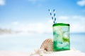 Cocktail with ice, rum, lemon and mint in a glass on beach Royalty Free Stock Photo
