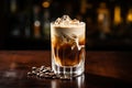 Cocktail layered baileys irish cream iced coffee on bar counter in a restaurant, pub. Drink with liqueur. Fresh prepared alcoholic