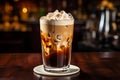 Cocktail layered baileys irish cream iced coffee on bar counter in a restaurant, pub. Drink with liqueur. Fresh prepared alcoholic