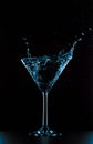 Cocktail martini glass splash on black background Royalty Free Stock Photo