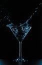 Cocktail martini glass splash on black background Royalty Free Stock Photo