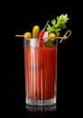Cocktail mix with vodka and tomato juice bloody mary with celery,olive,pickle and onion on black background Royalty Free Stock Photo